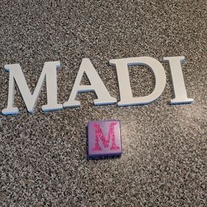 MADI white letters and purple/pink sparkle M